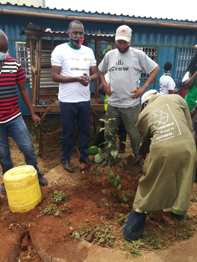 James Mbaluka planting a tree at bus park for WED 05-06-2020
